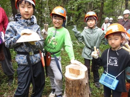 伐倒木の前で記念撮影をする子どもたち